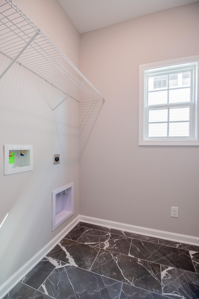 laundry area with laundry area, baseboards, marble finish floor, and electric dryer hookup