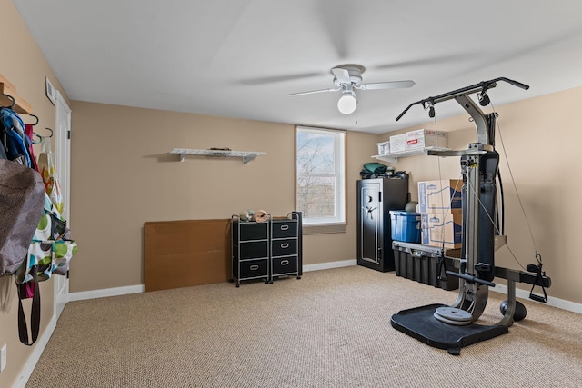 exercise room with carpet flooring, baseboards, and a ceiling fan