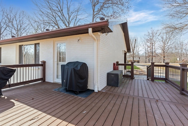 wooden deck featuring a grill