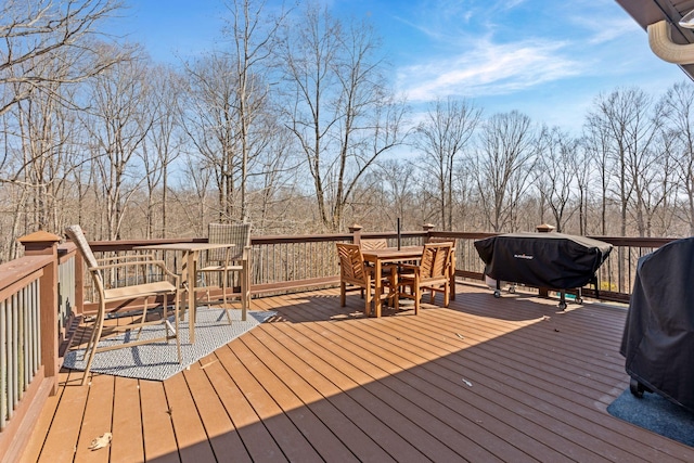 deck with area for grilling and outdoor dining space