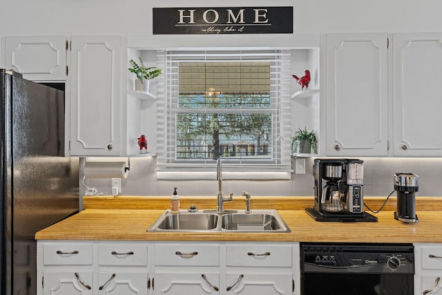 kitchen with a sink, black appliances, and white cabinetry