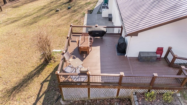 deck featuring a yard and a grill