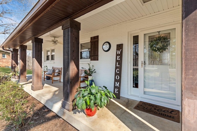 entrance to property featuring brick siding and covered porch