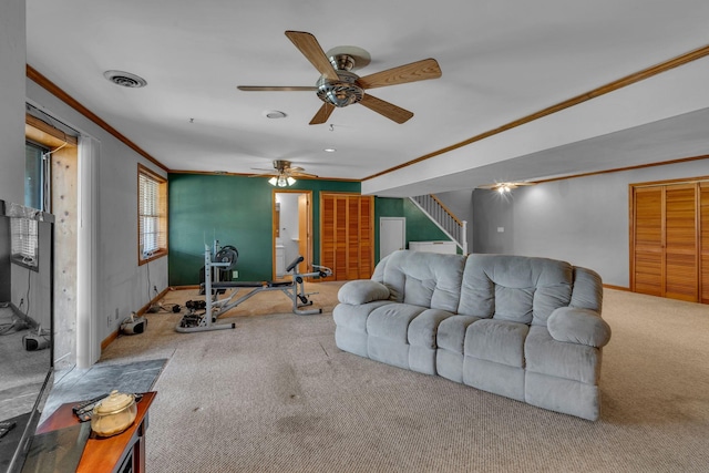 carpeted living area featuring visible vents, ornamental molding, a ceiling fan, stairway, and baseboards