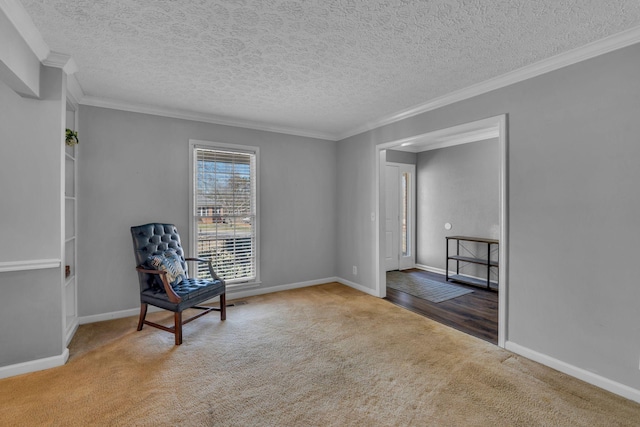 unfurnished room with ornamental molding, a textured ceiling, baseboards, and carpet floors