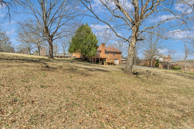 view of yard featuring a wooden deck and stairway