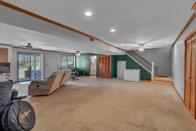 carpeted living room with visible vents, recessed lighting, stairway, crown molding, and ceiling fan