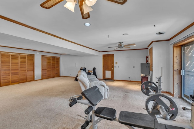 workout area featuring crown molding, carpet, and ceiling fan