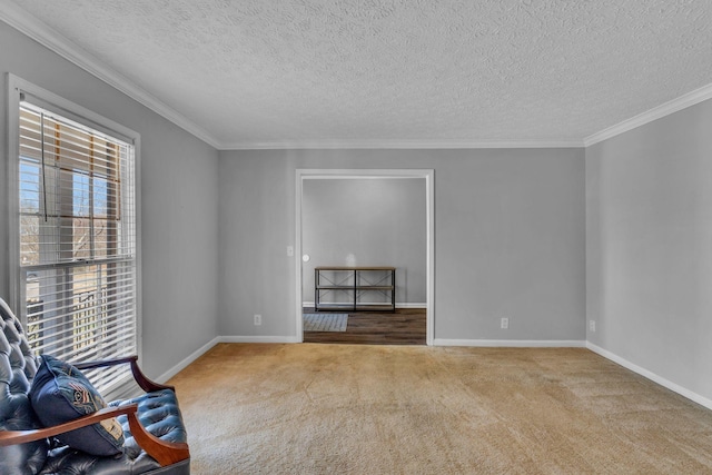 unfurnished room with carpet flooring, a healthy amount of sunlight, crown molding, and baseboards