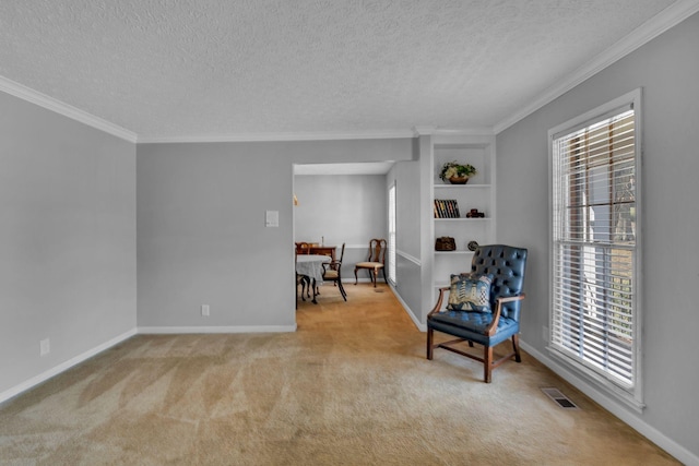 sitting room featuring visible vents, a healthy amount of sunlight, crown molding, and carpet floors