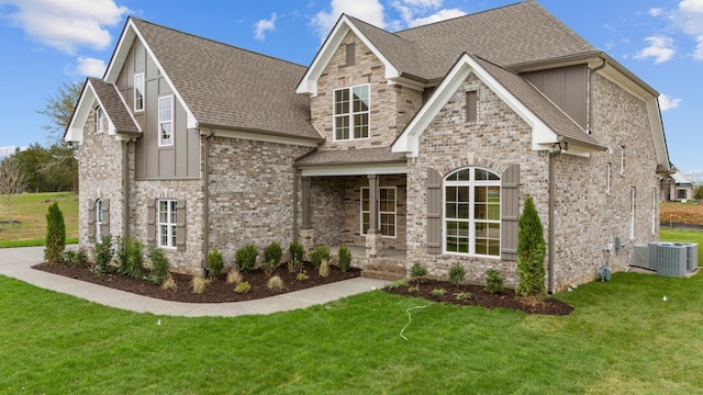 view of front of property with board and batten siding, a shingled roof, and a front lawn