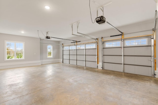 garage featuring recessed lighting, a garage door opener, and baseboards