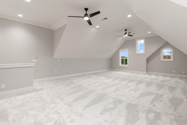 bonus room with visible vents, ceiling fan, baseboards, lofted ceiling, and light carpet