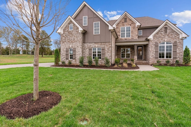 craftsman-style home featuring brick siding, board and batten siding, and a front yard