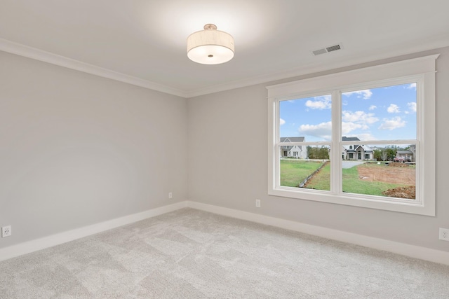 unfurnished room with visible vents, baseboards, light colored carpet, and crown molding