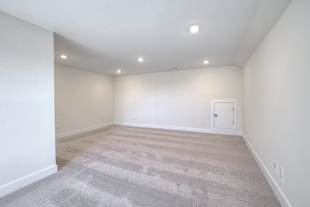 empty room with recessed lighting, light colored carpet, and baseboards