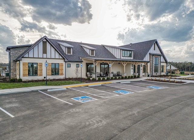 view of building exterior with uncovered parking