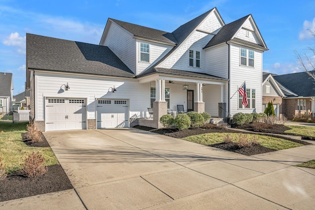 view of front of house with a porch, an attached garage, driveway, and a shingled roof