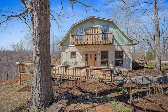 back of property with a balcony