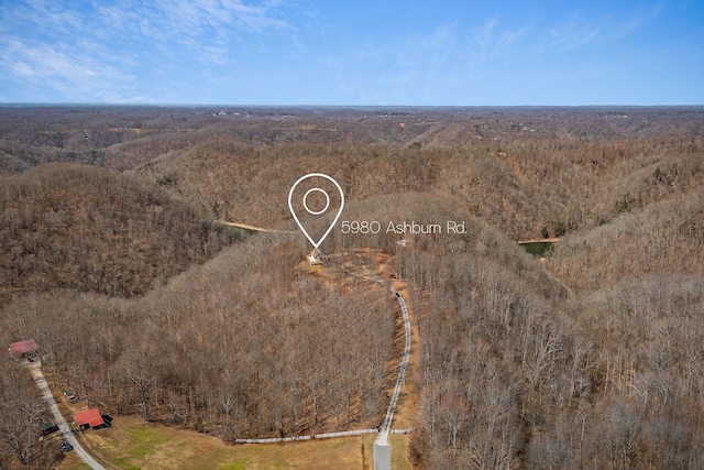 birds eye view of property with a wooded view