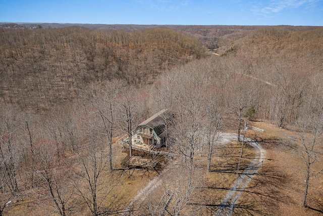 drone / aerial view with a wooded view