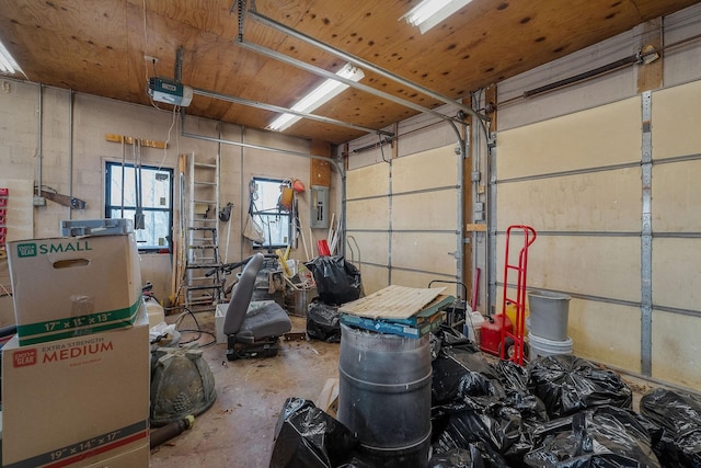 garage with electric panel, a garage door opener, and wooden ceiling