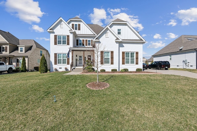 view of front of home featuring a front yard, brick siding, board and batten siding, and a residential view