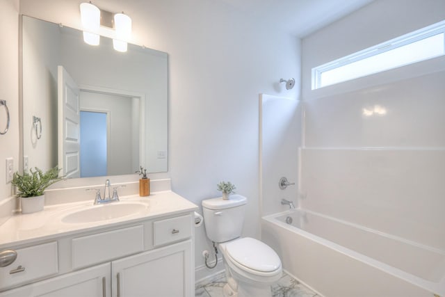 full bath featuring toilet, marble finish floor, tub / shower combination, baseboards, and vanity