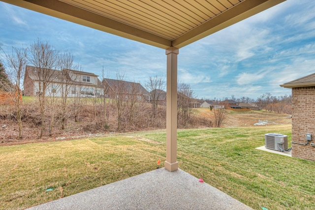 view of yard with central air condition unit and a patio