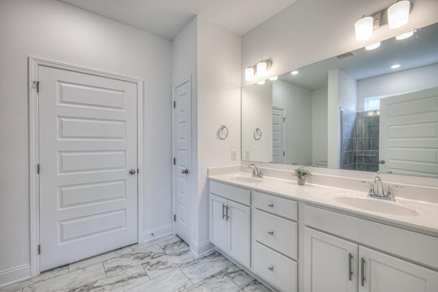 bathroom with a sink, tiled shower, marble finish floor, and double vanity