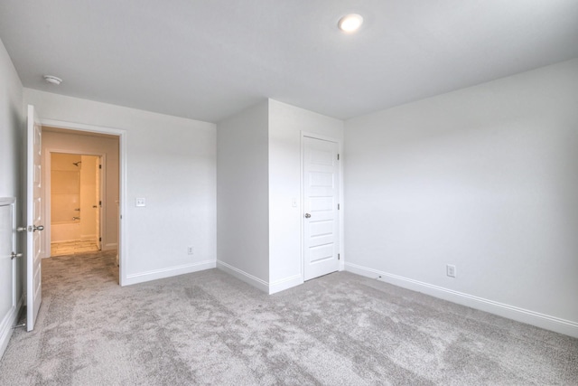 unfurnished bedroom featuring carpet flooring and baseboards