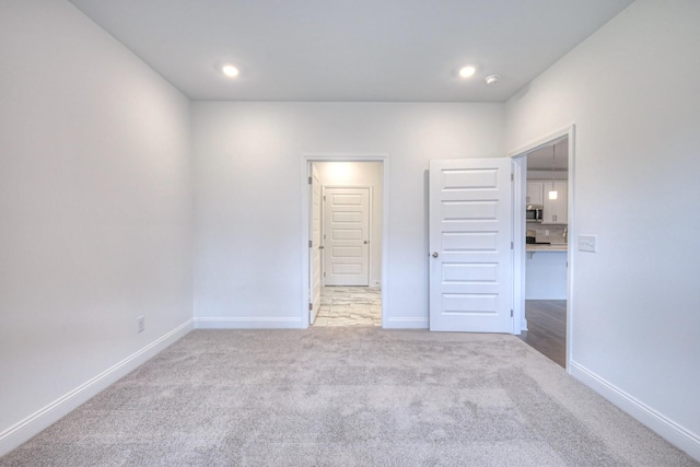 unfurnished bedroom with recessed lighting, baseboards, and carpet floors