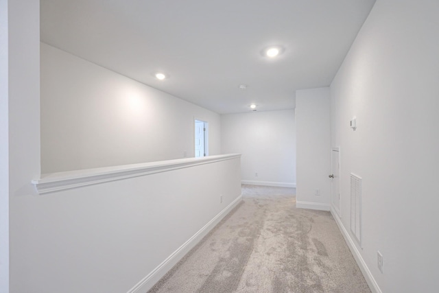 hall featuring visible vents, recessed lighting, baseboards, and carpet