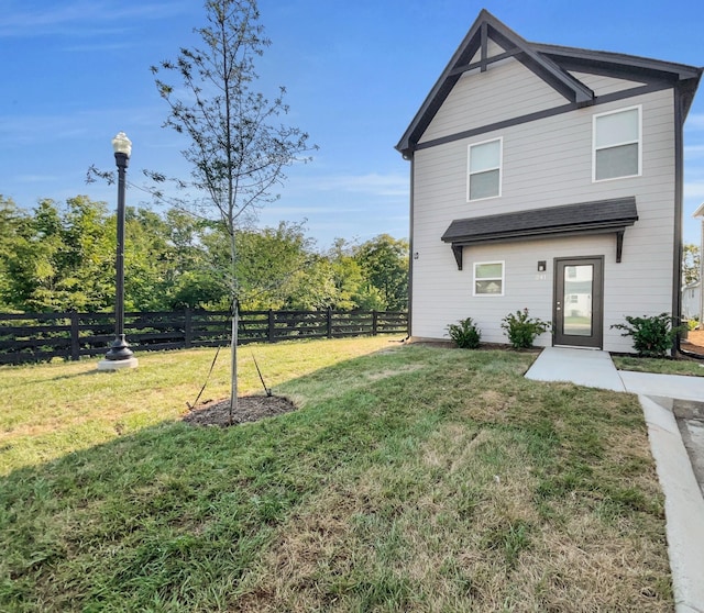 exterior space with a lawn and fence