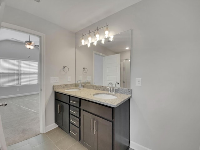 bathroom featuring double vanity, baseboards, a ceiling fan, and a sink