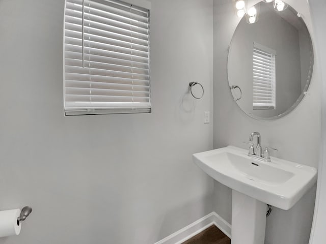 bathroom featuring baseboards and a sink