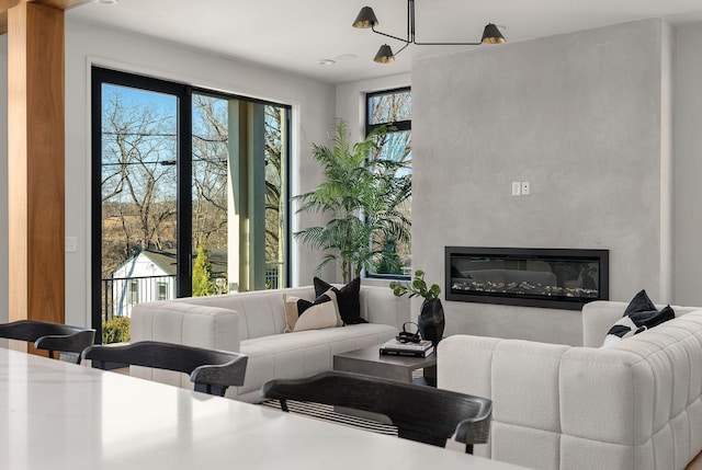 living room featuring a glass covered fireplace