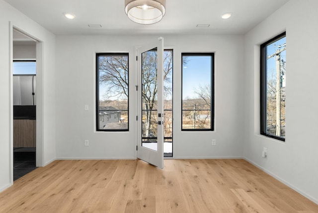 interior space with recessed lighting, baseboards, and light wood-style floors