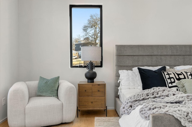 bedroom featuring baseboards and wood finished floors