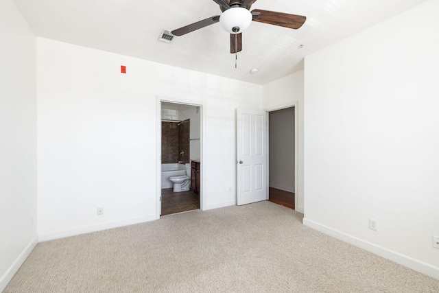 unfurnished bedroom featuring visible vents, carpet floors, baseboards, and ensuite bath