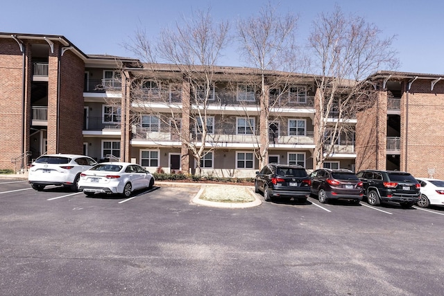 view of building exterior with uncovered parking