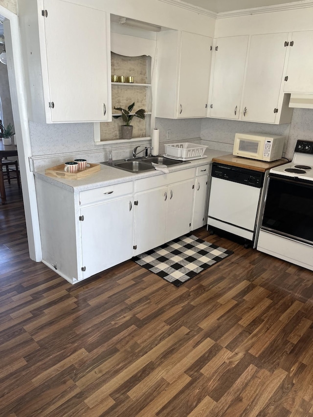 kitchen with a sink, open shelves, light countertops, white appliances, and dark wood-style flooring