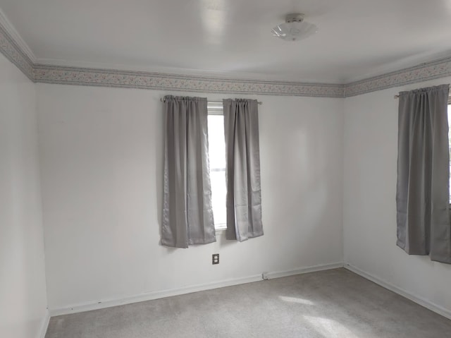 unfurnished room featuring baseboards and crown molding