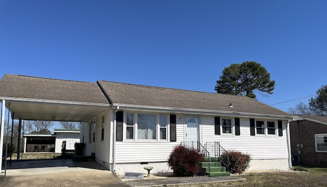 view of front facade featuring crawl space, a carport, roof with shingles, and concrete driveway