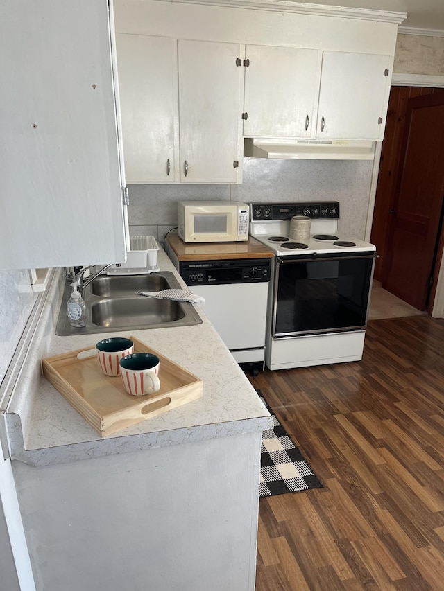 kitchen with white appliances, dark wood finished floors, a sink, under cabinet range hood, and white cabinetry