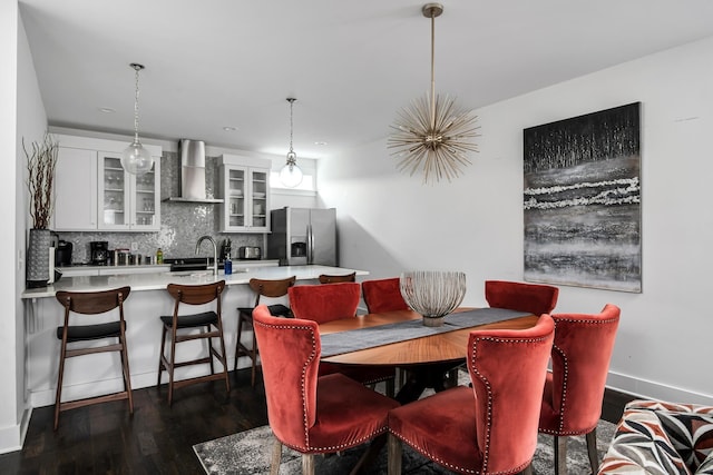 dining space with dark wood-type flooring and baseboards