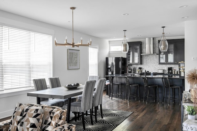 dining area featuring dark wood-type flooring, recessed lighting, and baseboards