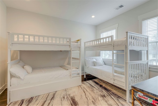 bedroom with recessed lighting, visible vents, multiple windows, and wood finished floors