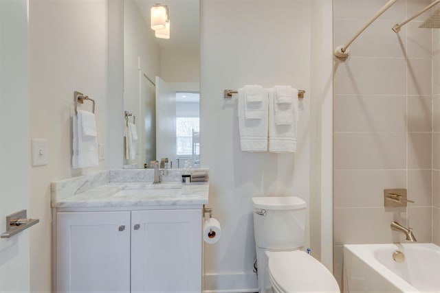 bathroom featuring toilet, vanity, and bathing tub / shower combination