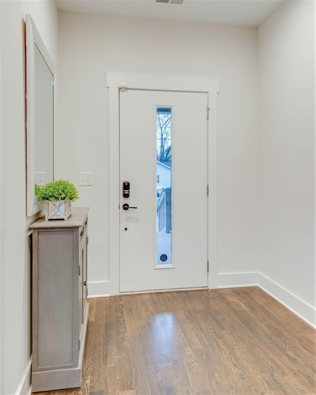 entrance foyer with visible vents, baseboards, and wood finished floors